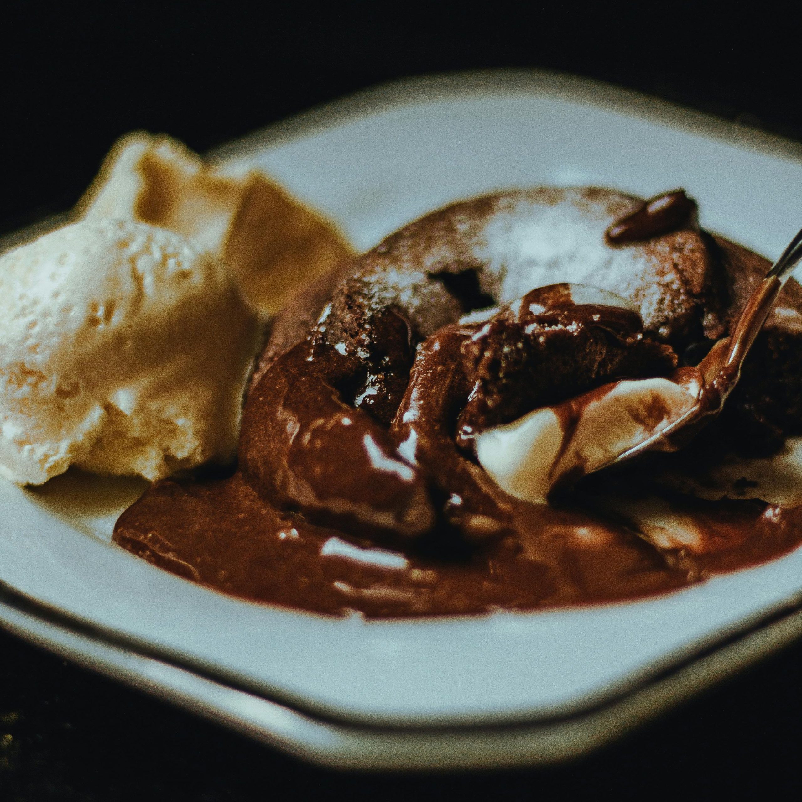 A mouthwatering close-up of a rich chocolate lava cake paired with creamy vanilla ice cream.
